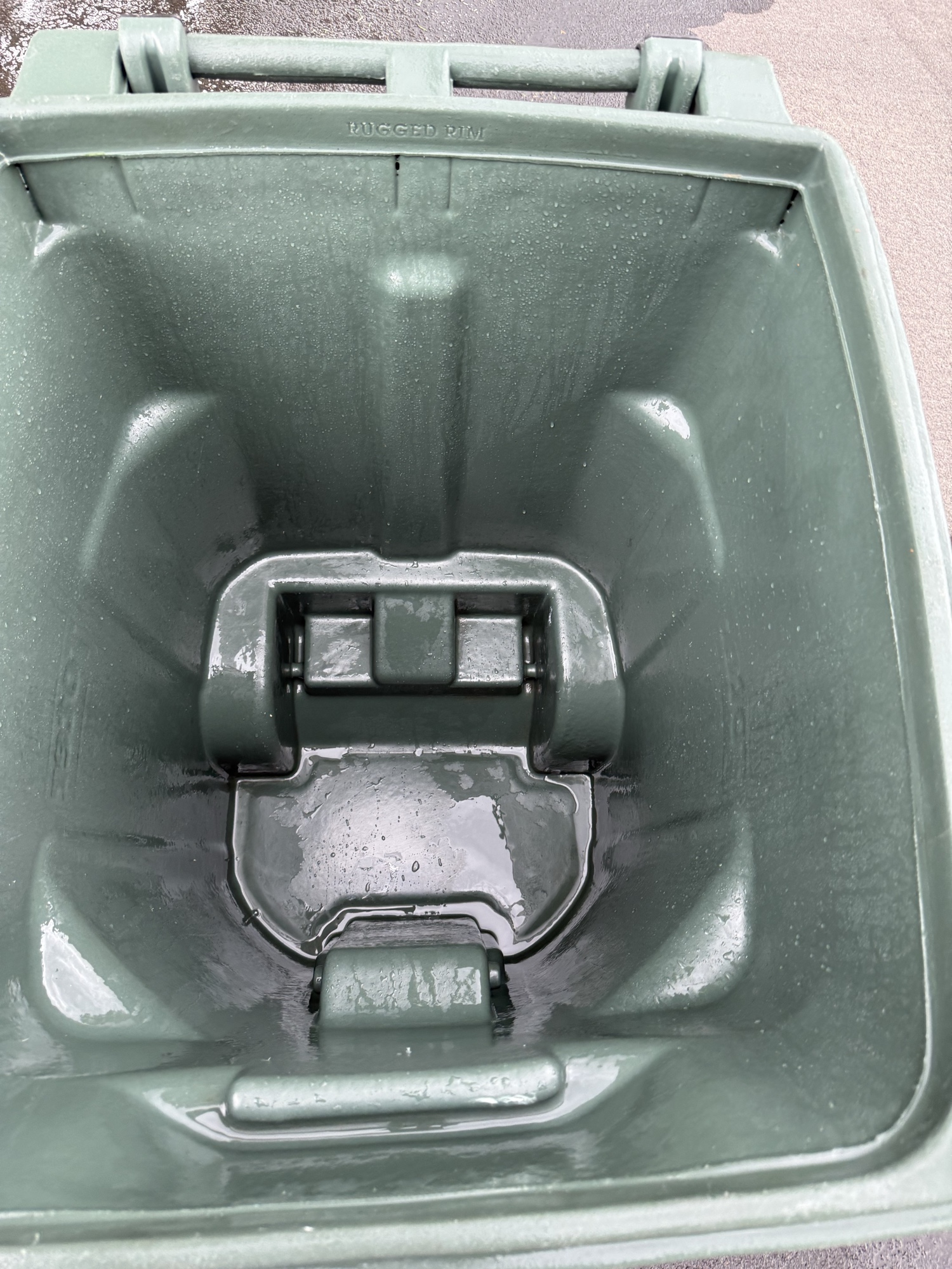 Clean green trash bin interior after Bin Boss pressure washing