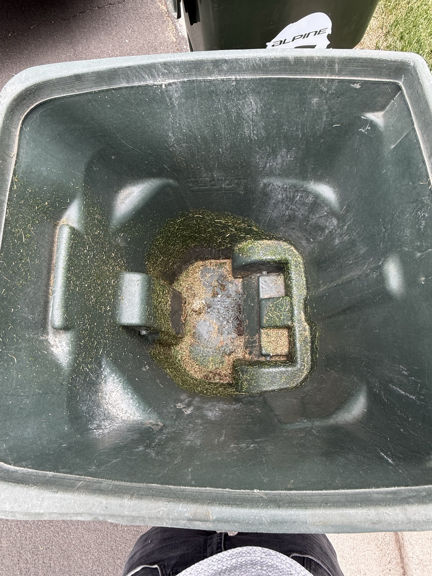 Dirty green trash bin interior before Bin Boss pressure washing
